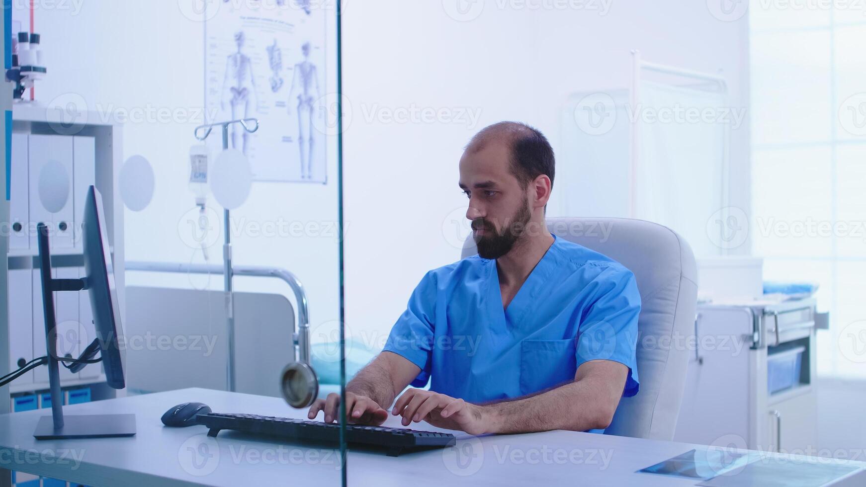Assistant in blue medical uniform giving doctor patient x-ray image in hospital cabinet. Medic examining patient radiography before giving a treatment to cure his affection. photo