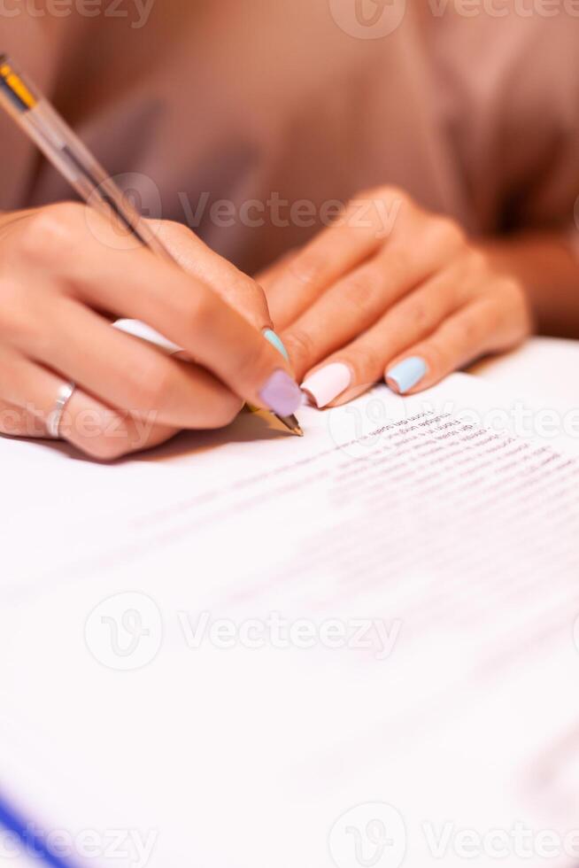 Close up of woman writing on clipboard during podcast. Influencer taking notes on clipboard while talking with followers during live on social media, creative online show On-air production broadcast photo