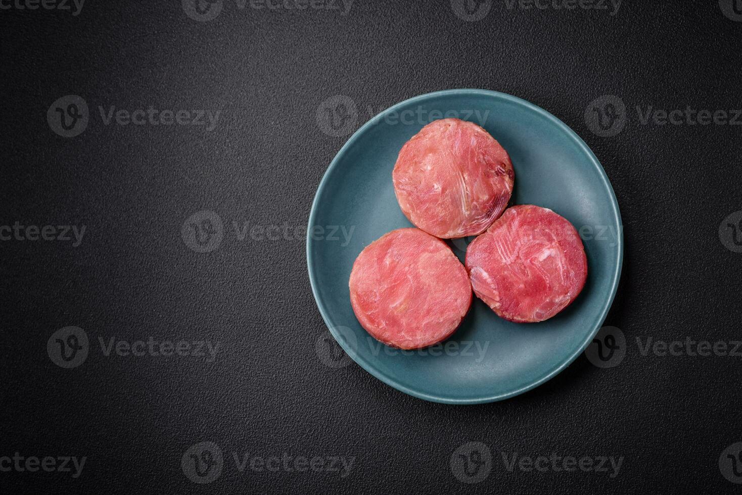 Round shape steaks of raw juicy tuna with salt and spices photo