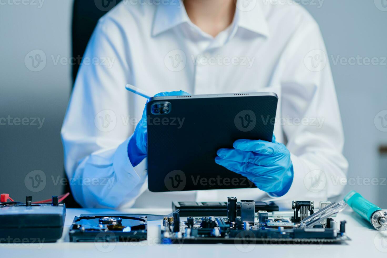 Electronics technician, electronic engineering electronic repair, electronics measuring and testing, repair and maintenance concepts.uses a voltage meter to check and upgrade photo