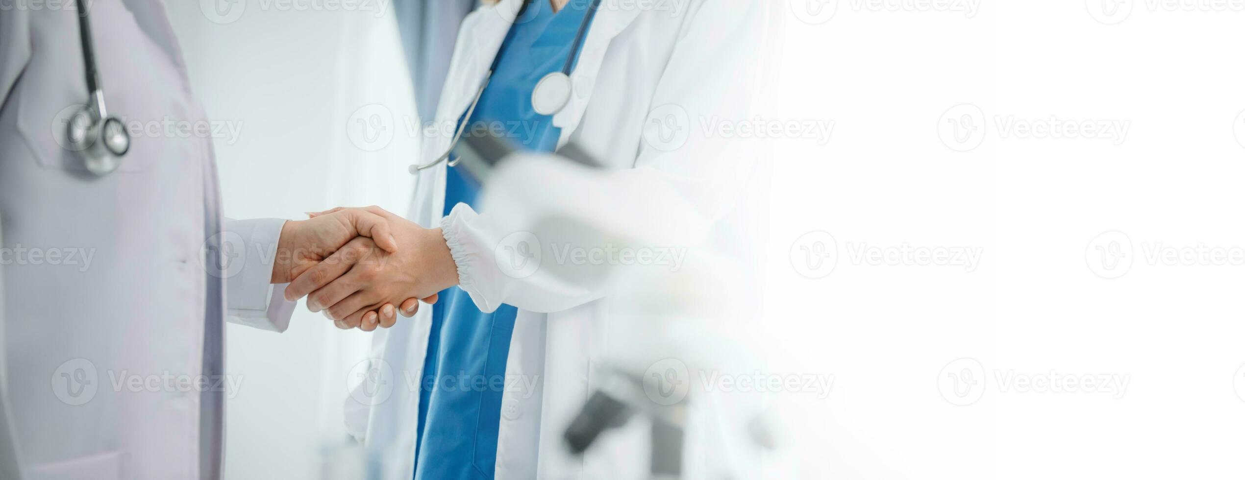 Doctor handshake and partnership in healthcare, medicine or trust for collaboration, unity or support.Team of medical experts shaking hands in teamwork for or success photo
