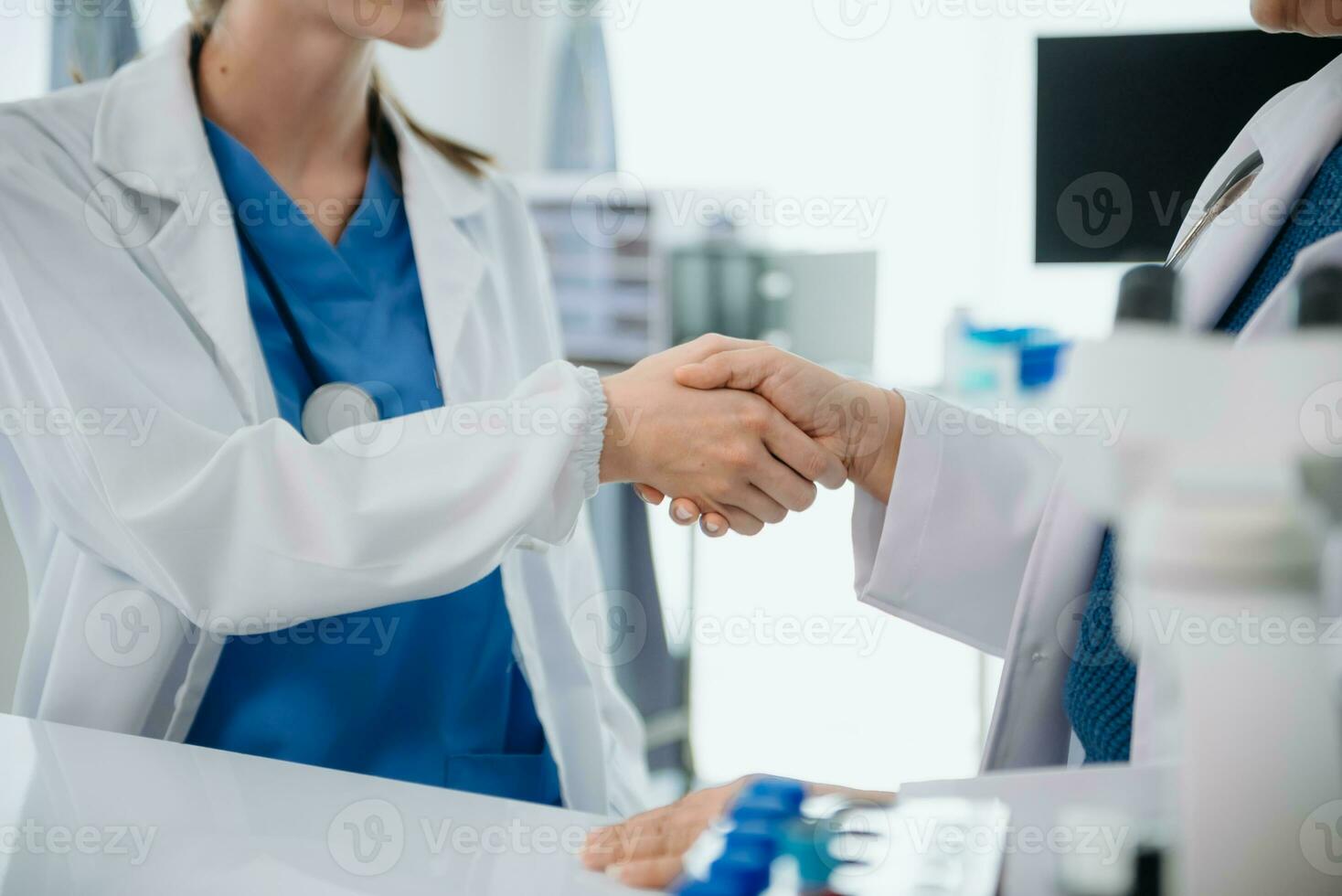 Doctor handshake and partnership in healthcare, medicine or trust for collaboration, unity or support.Team of medical experts shaking hands in teamwork for or success photo