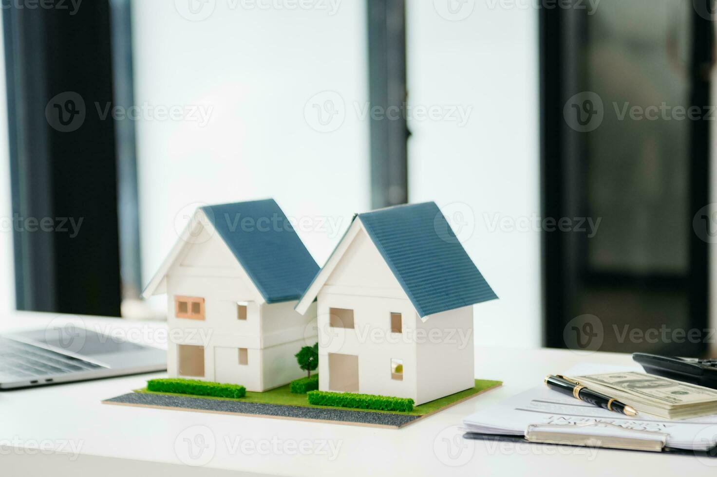 balancing the property sector The real estate agent is explaining the house style to see the house design and the purchase agreement. model house photo