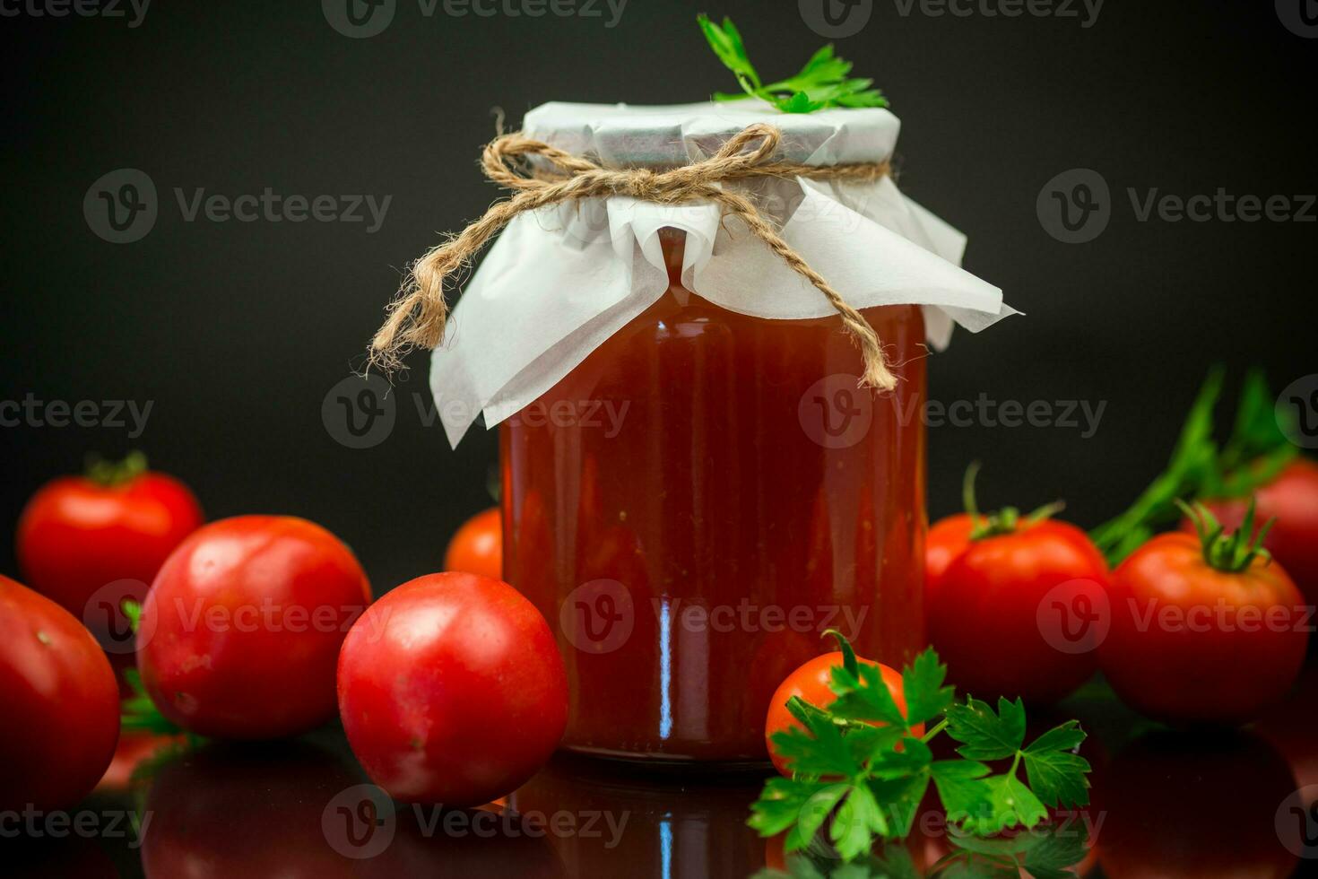 Cooked homemade tomato juice canned in a jar of natural tomatoes. photo