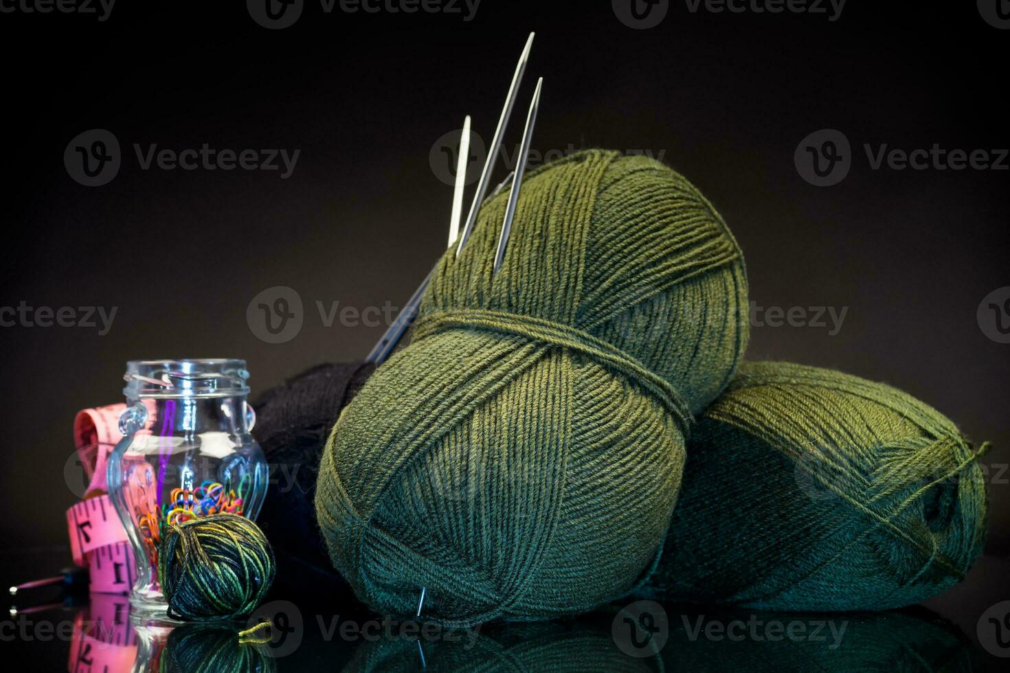 wool yarn, knitting needles and other tools for hand knitting. photo