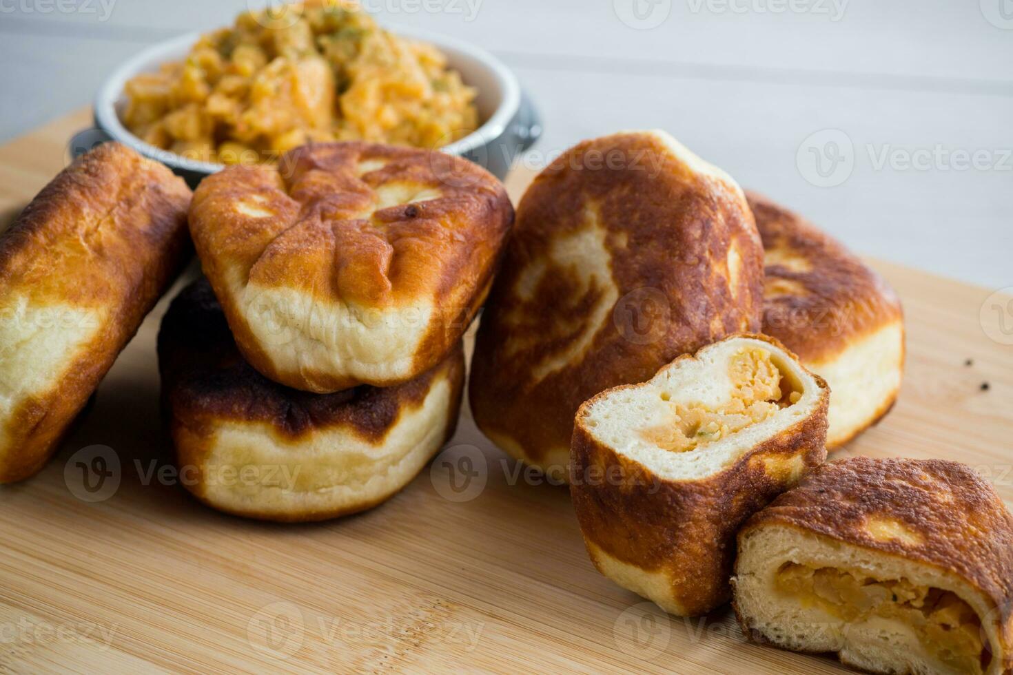 Fried Lenten pies filled with cooked peas inside, on a wooden table. photo