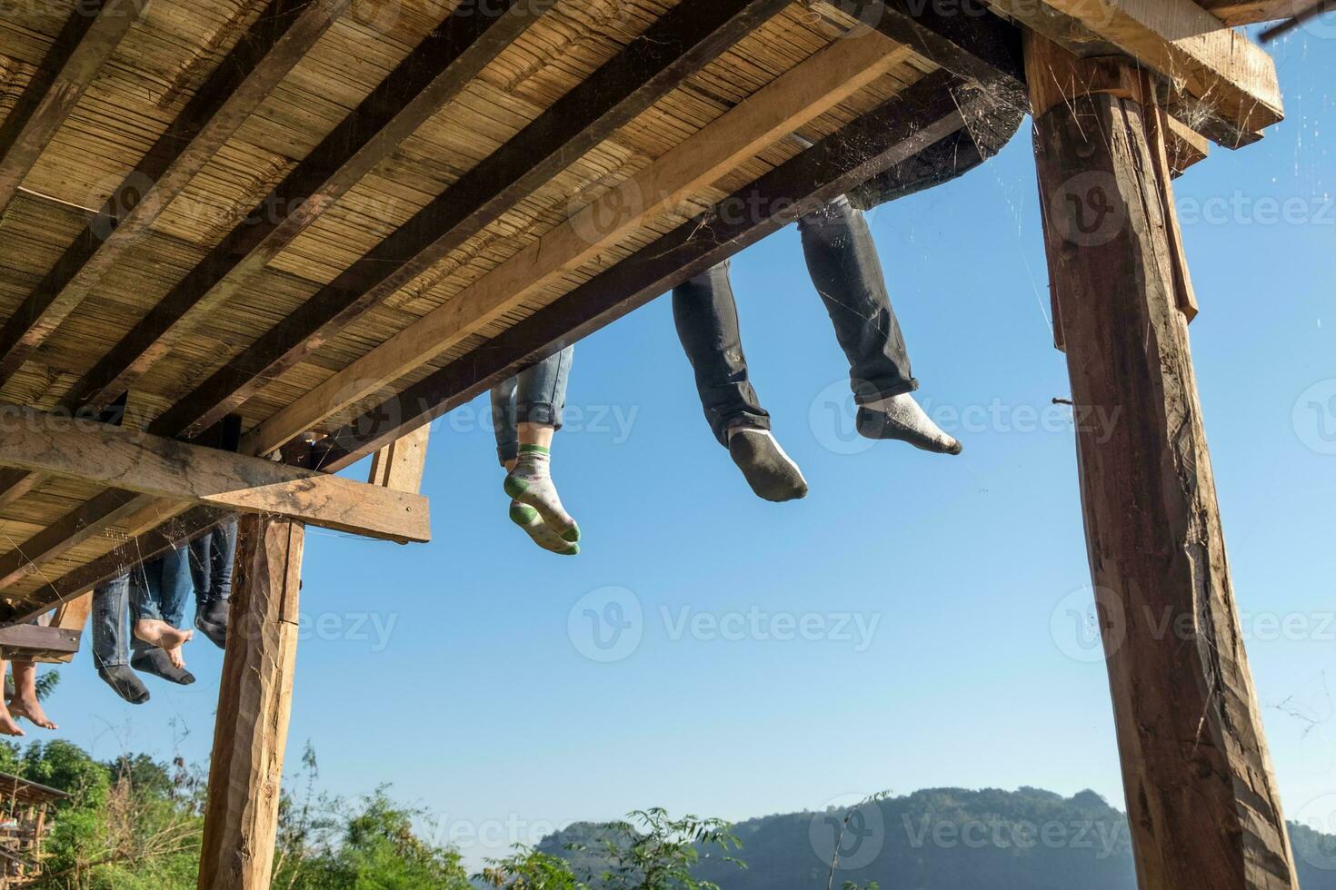 Tourists sitting legs hanging on terrace photo