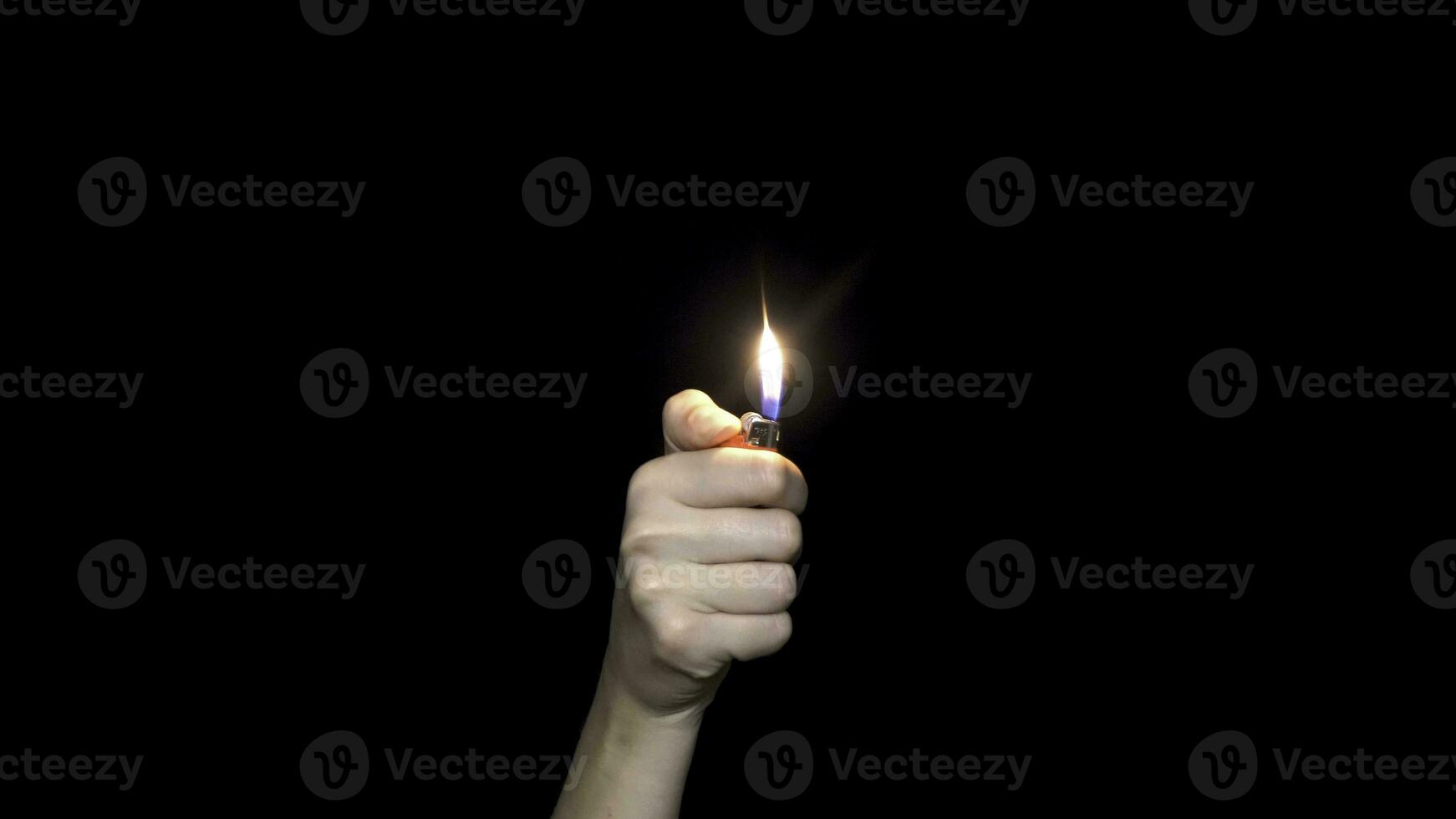 Male hand holding a red lighter, isolated on white background. Hand holding burning gas lighter. photo