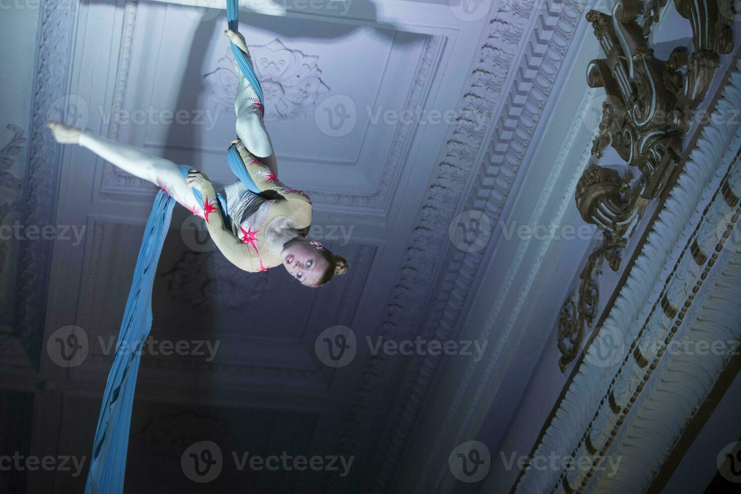 Speech gymnasts on the canvases. Girl on acrobatic canvases.Dangerous Circus Tricks.Aerial gymnast photo