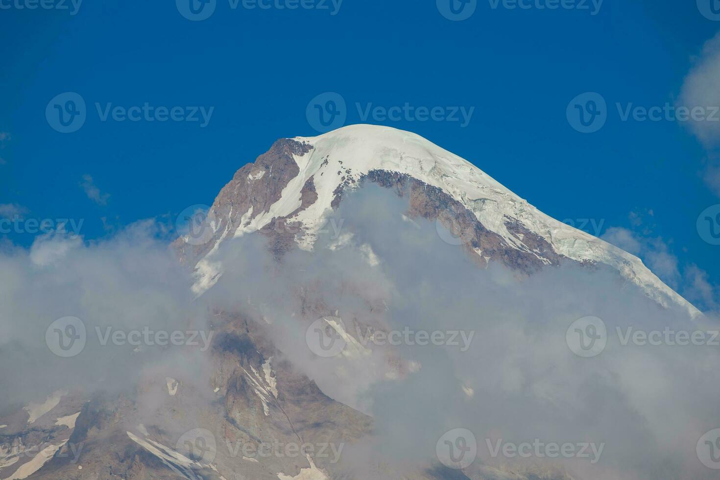 Majestic Mount Kazbeg in the clouds. photo