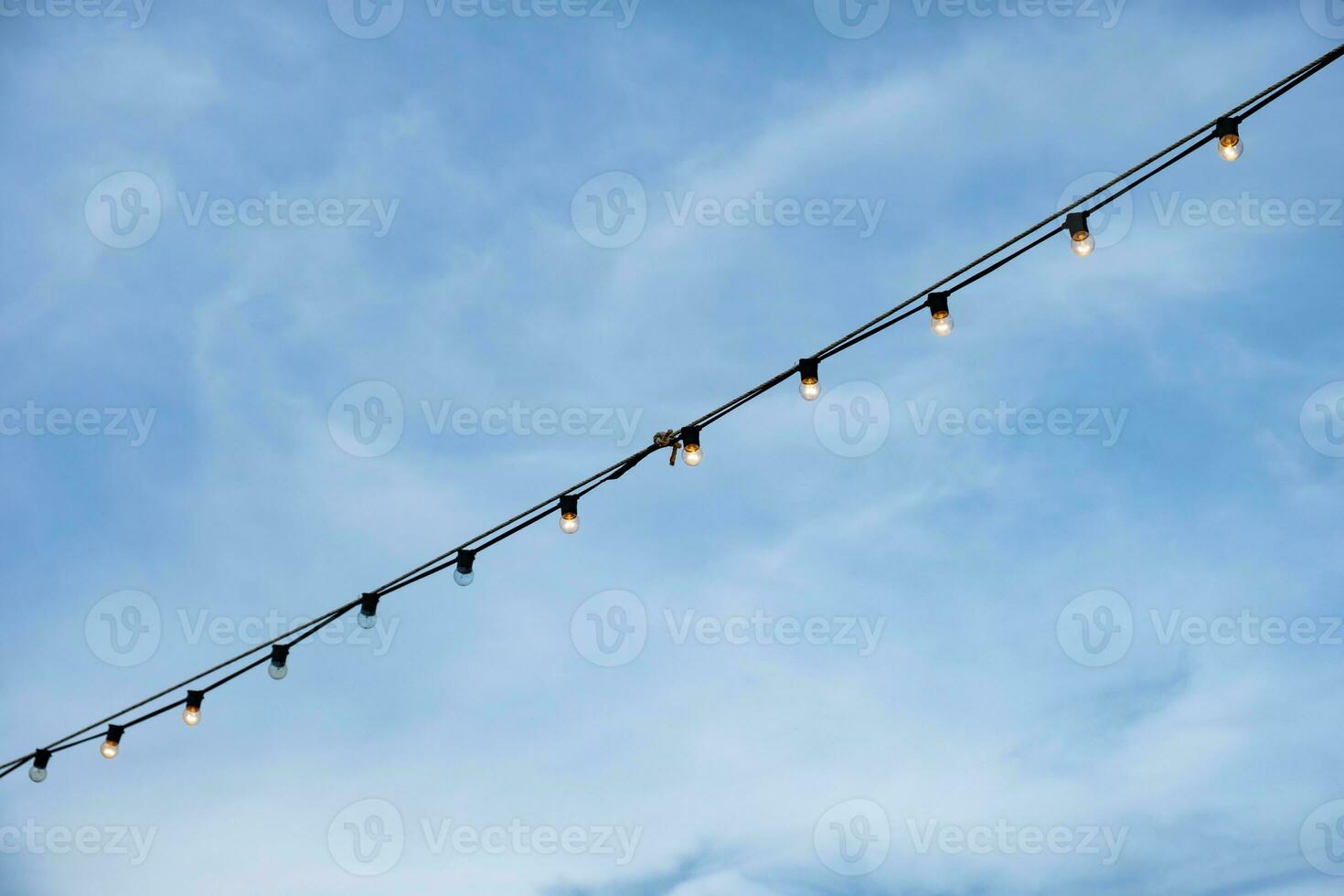 Electric wire dim hanging on blue sky photo