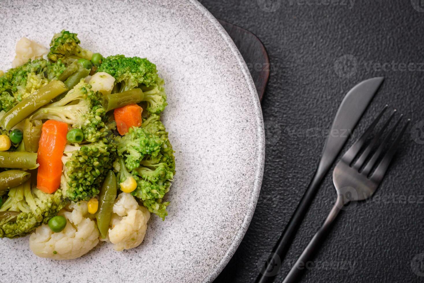 Delicious fresh vegetables steamed carrots, broccoli, cauliflower photo