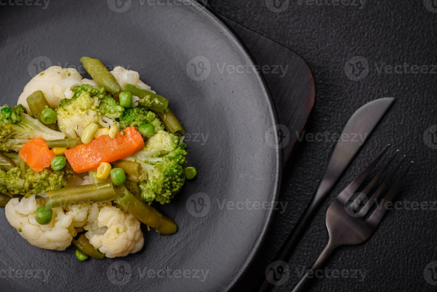 Delicious fresh vegetables steamed carrots, broccoli, cauliflower photo