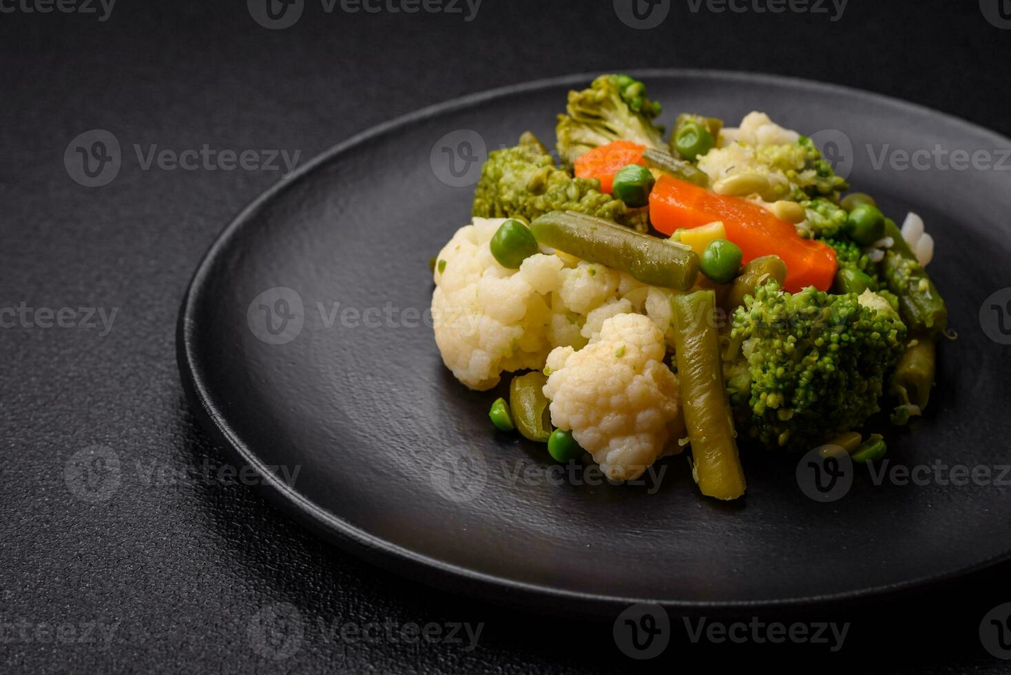 Delicious fresh vegetables steamed carrots, broccoli, cauliflower photo