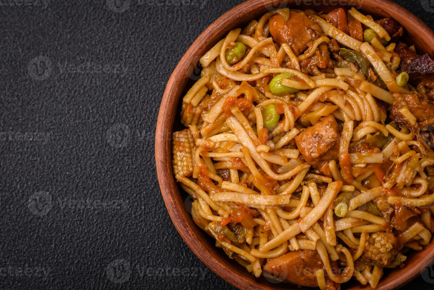 Delicious asian udon dish with vegetables, mushrooms, salt and spices photo