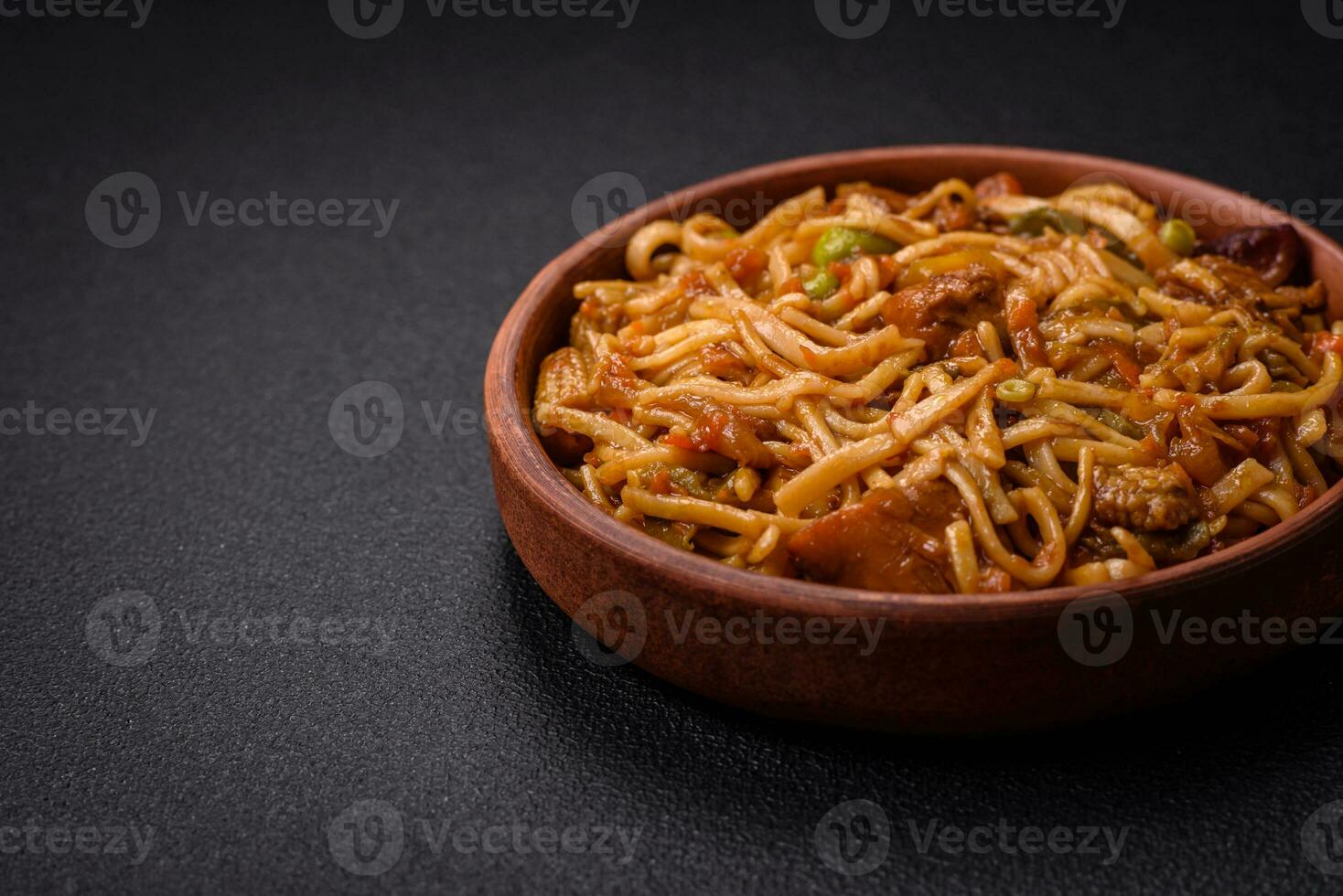Delicious asian udon dish with vegetables, mushrooms, salt and spices photo