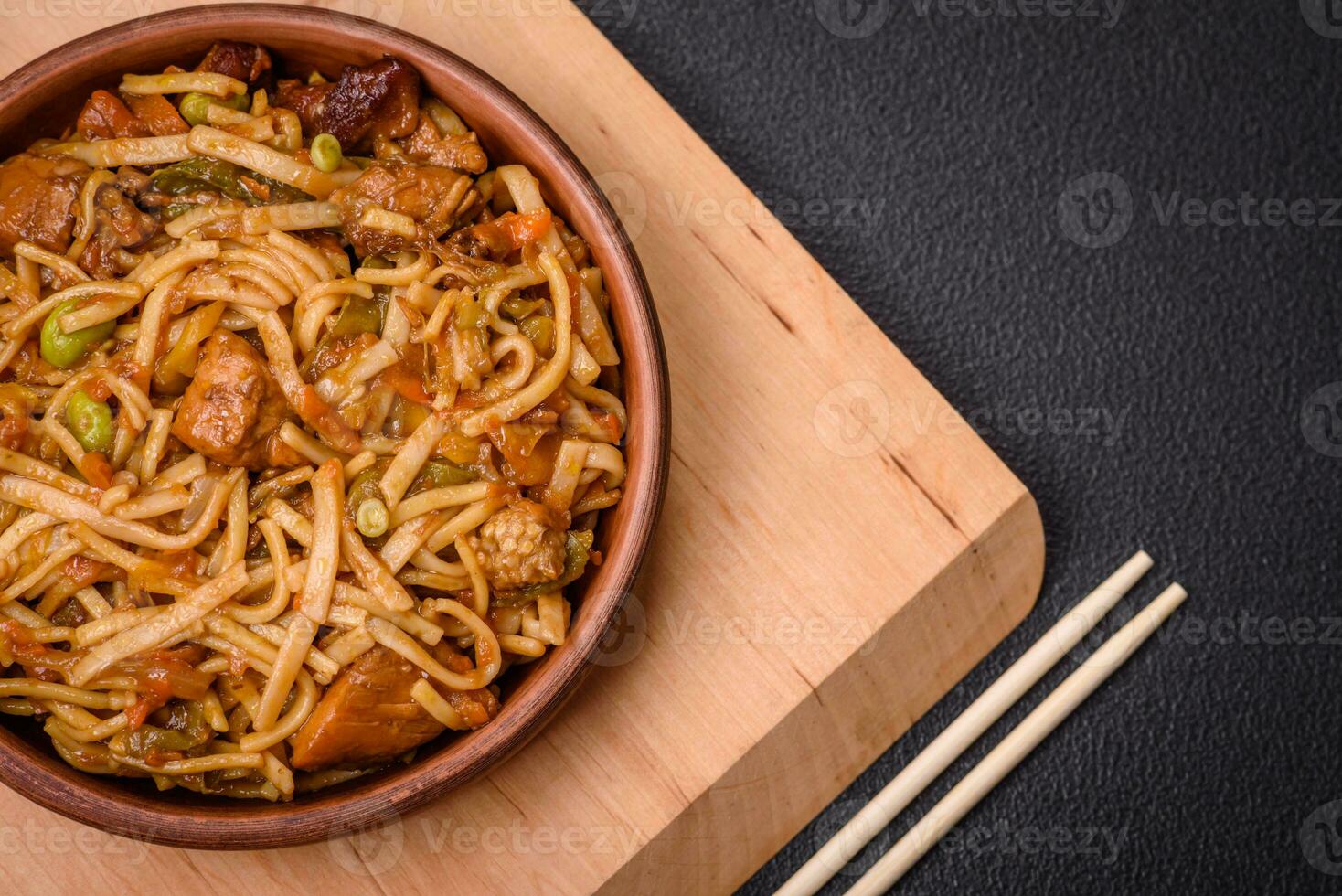 Delicious asian udon dish with vegetables, mushrooms, salt and spices photo