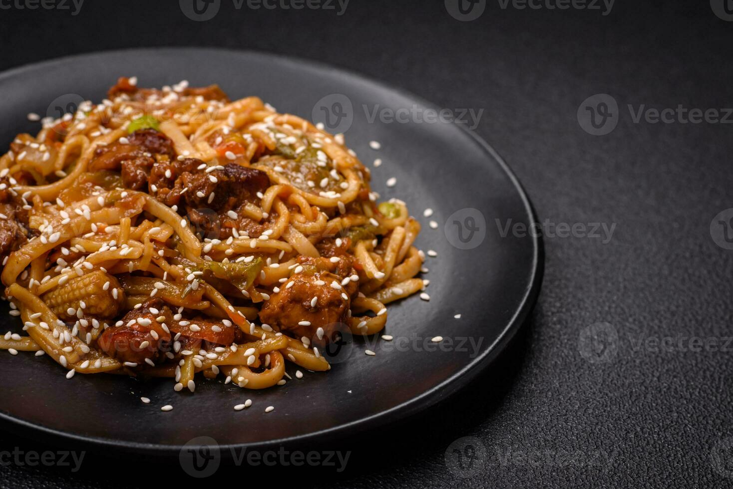 Delicious asian udon dish with vegetables, mushrooms, salt and spices photo
