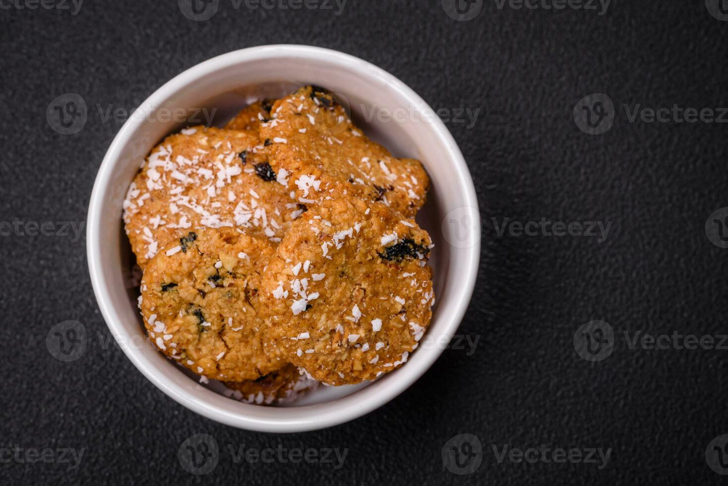 Delicious sweet round sponge cookies sprinkled with coconut flakes photo