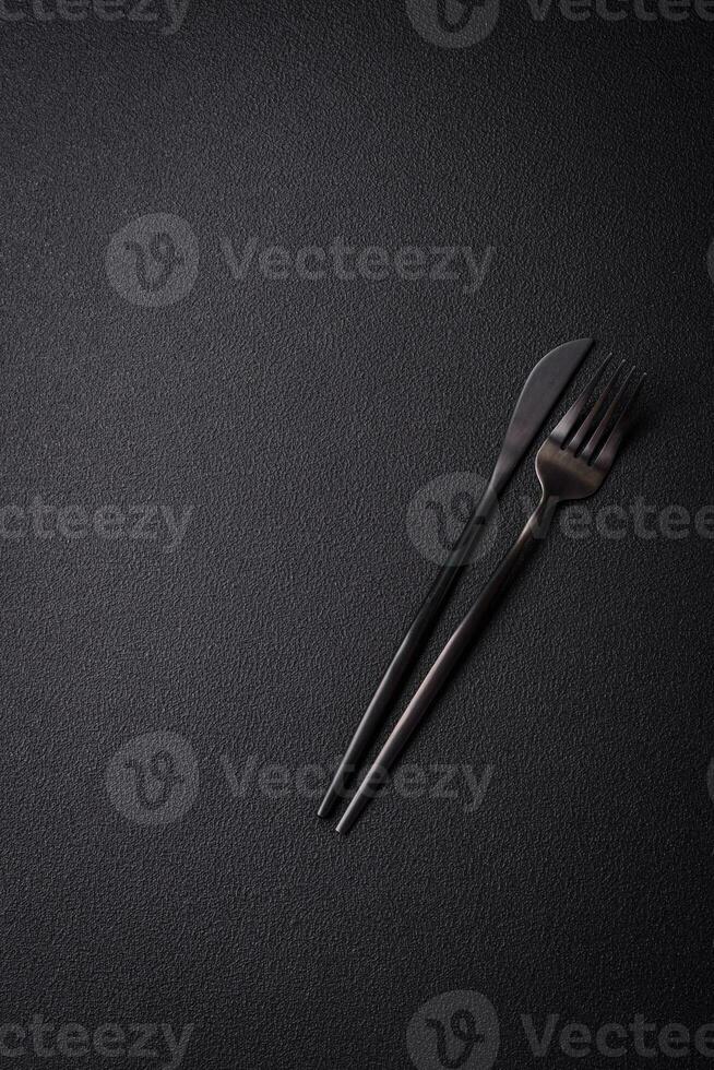 Kitchen knife and fork made of steel with copy space photo