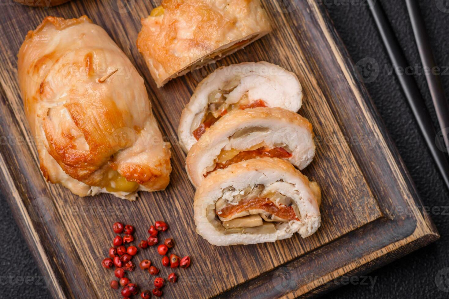 Delicious fresh meat roll made from chicken fillet, mushrooms, spices and herbs photo