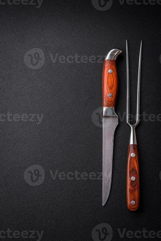 Kitchen knife and fork made of steel with copy space photo