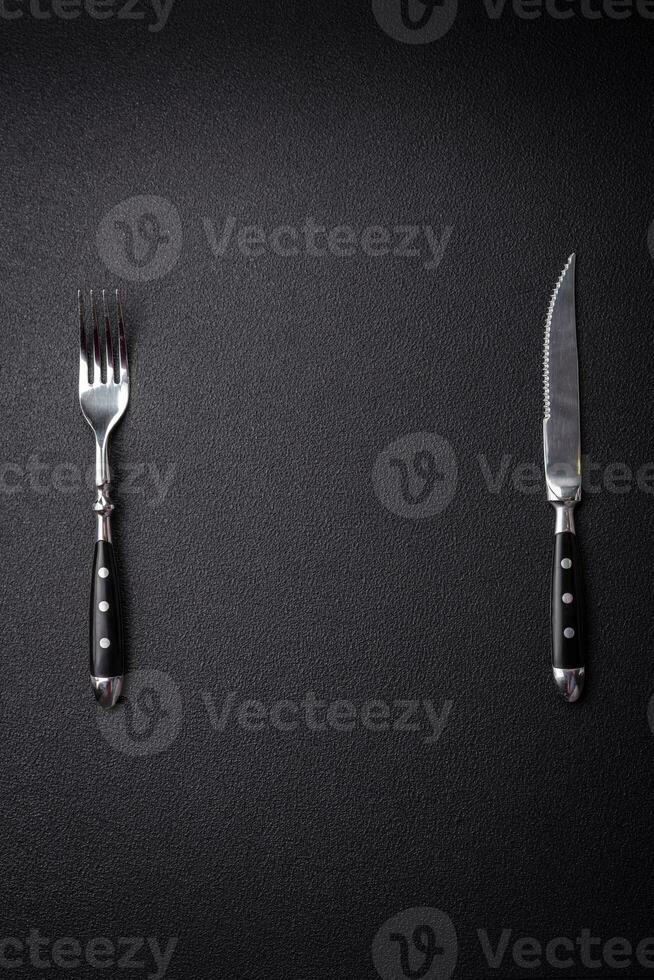 Kitchen knife and fork made of steel with copy space photo