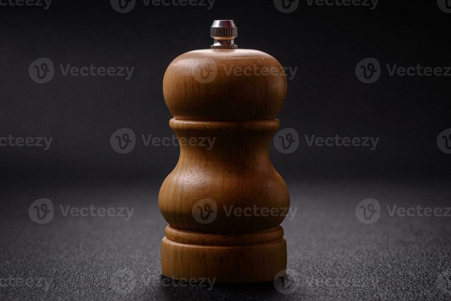 Beautiful wooden figured pepper shaker or salt shaker with a mill photo