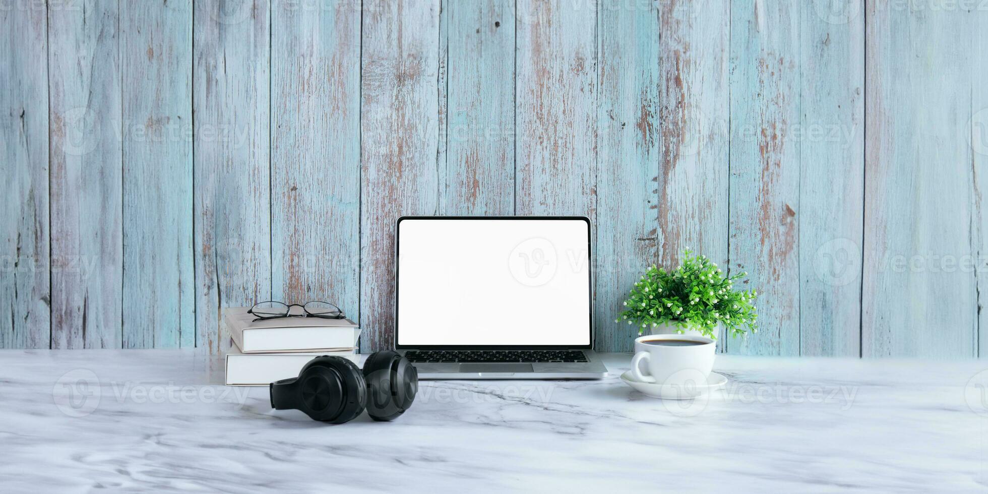 Laptop computer mockup blank white screen on table in wood background. Laptop with blank screen on table of workplace contemporary wood background photo