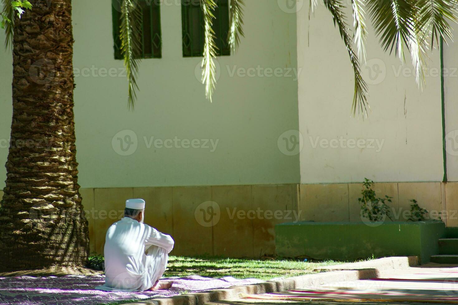 Muslim culture, a man next to a mosque photo