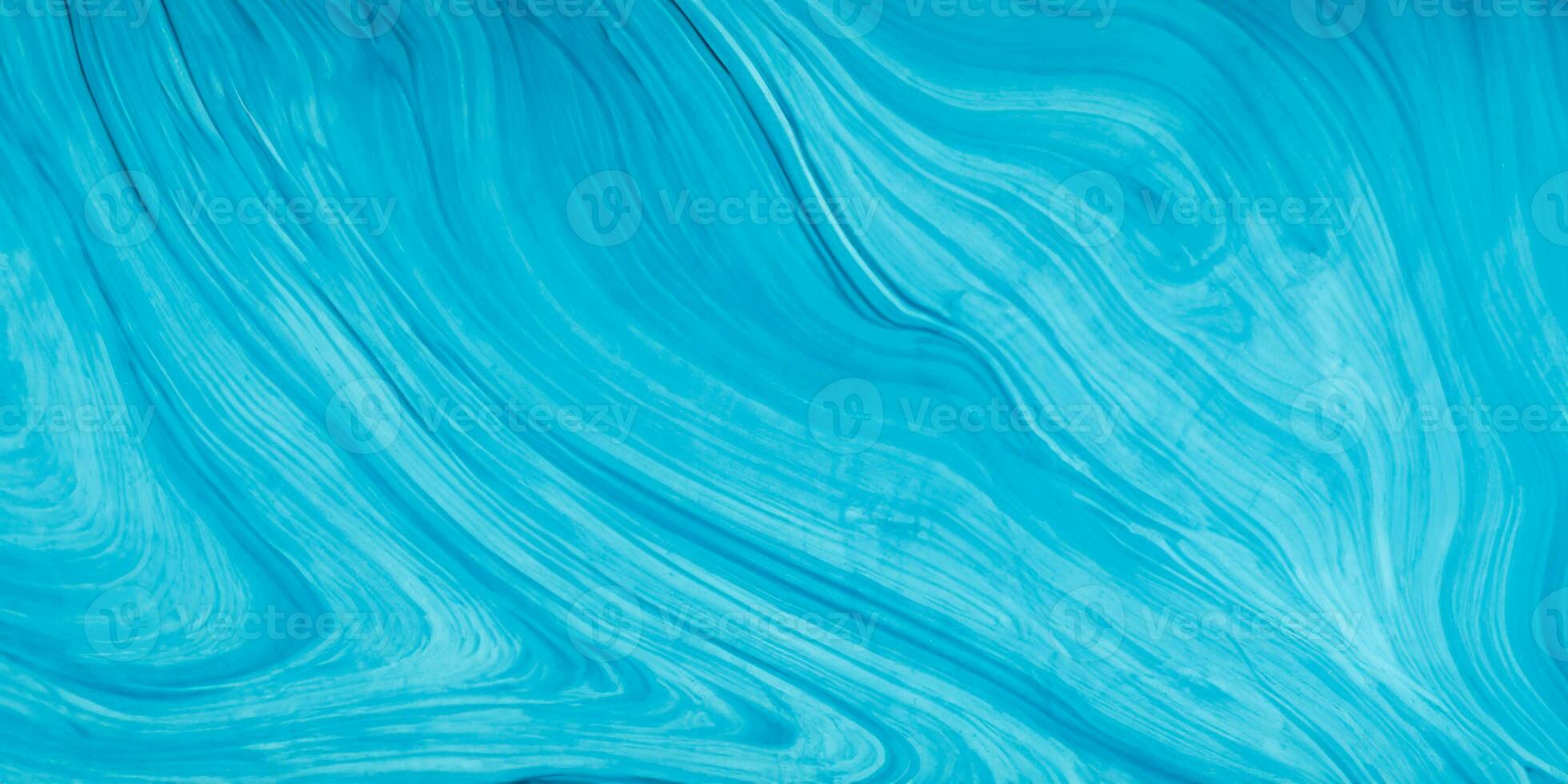 blue liquid paint on a surface with a wave pattern photo