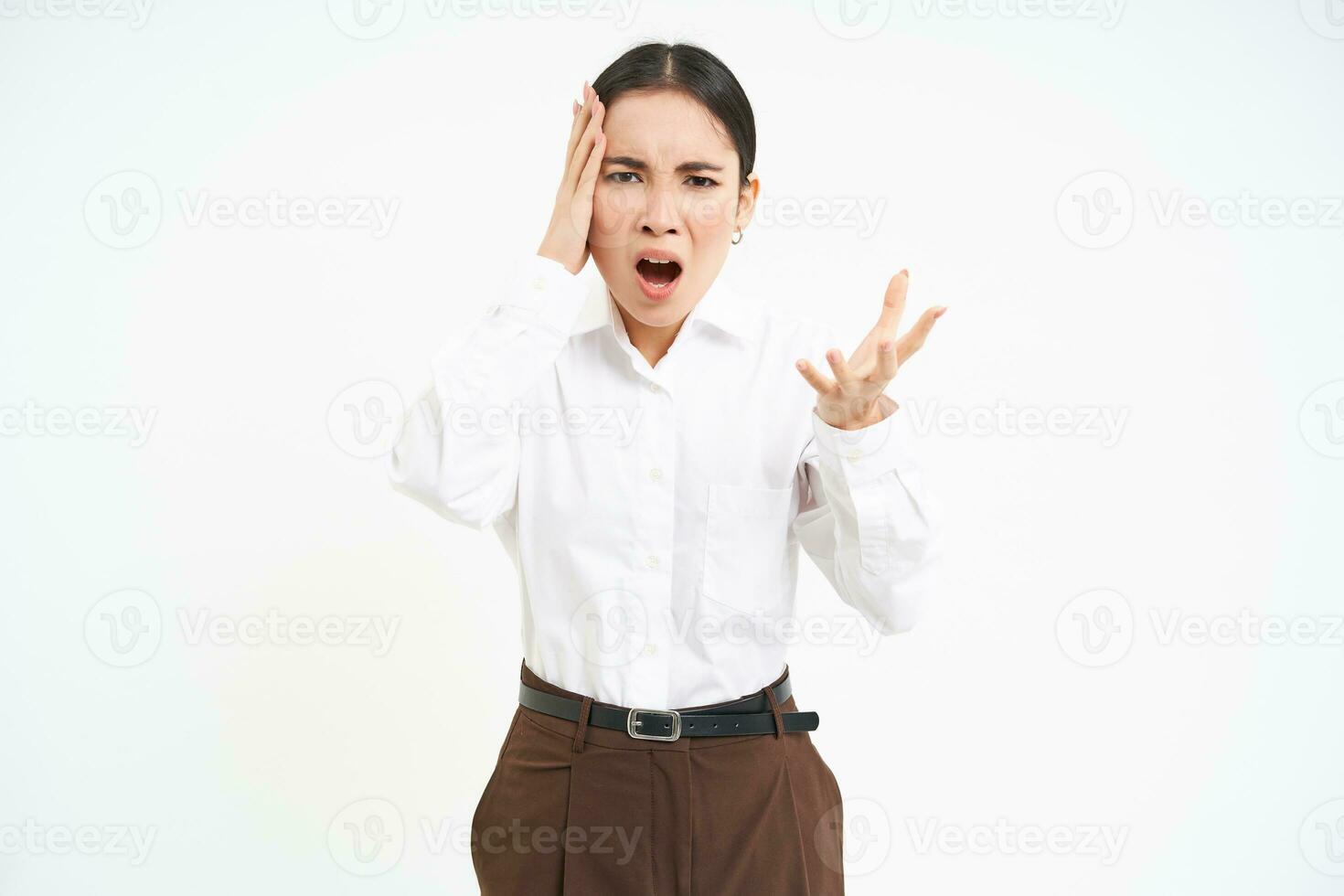 Angry businesswoman, yells and shakes hands at camera, screams at employee, white background photo
