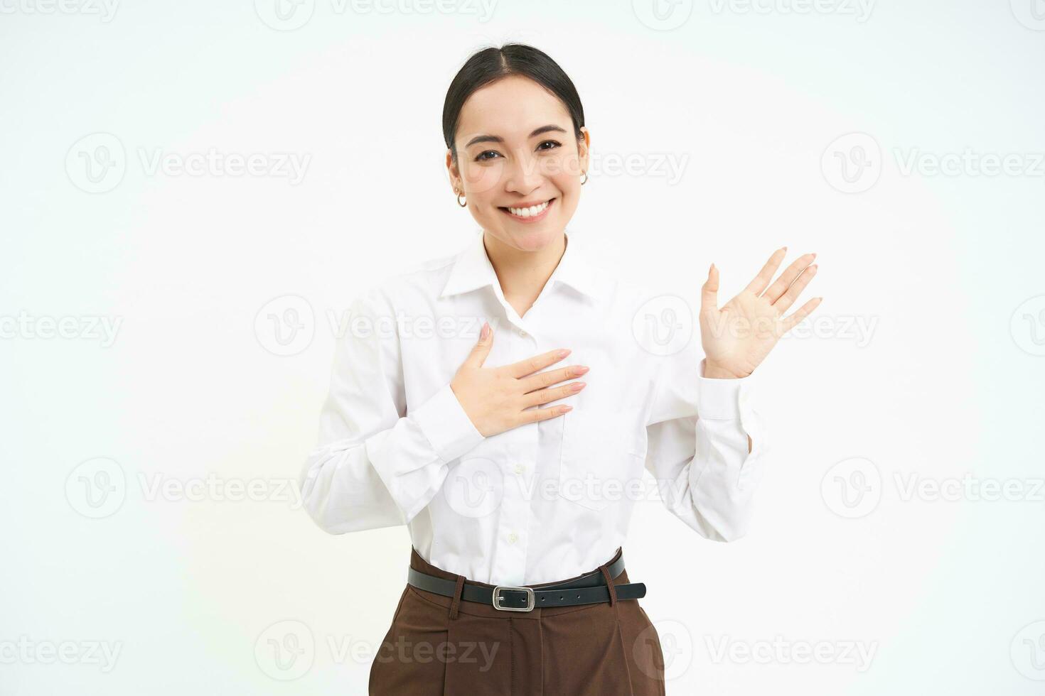 Friendly smiling businesswoman, introduces herself, says her name, stands over white background photo