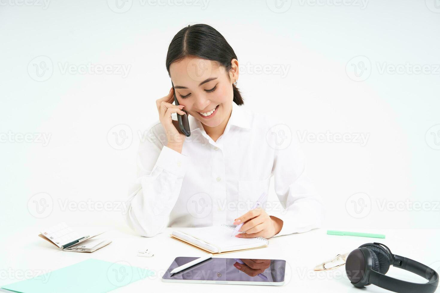 Image of asian woman in office, talks on cellphone, discuss work with client on mobile phone, white background photo