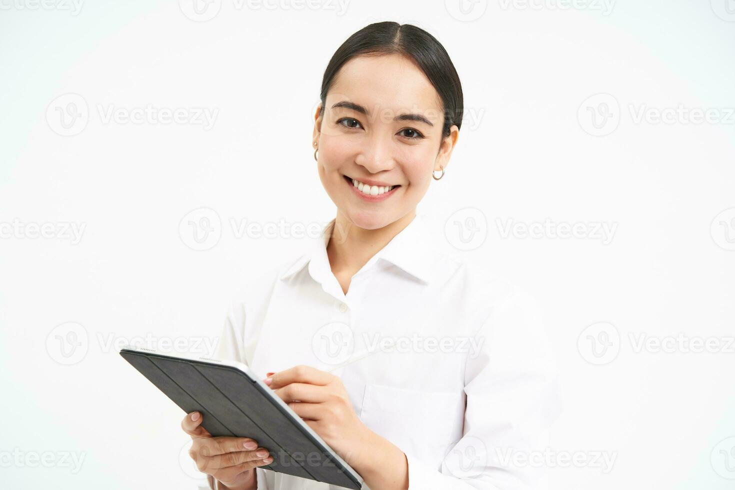 Portrait of businesswoman working on digital tablet, creating diagrams for meeting conference on gadget, standing over white background photo