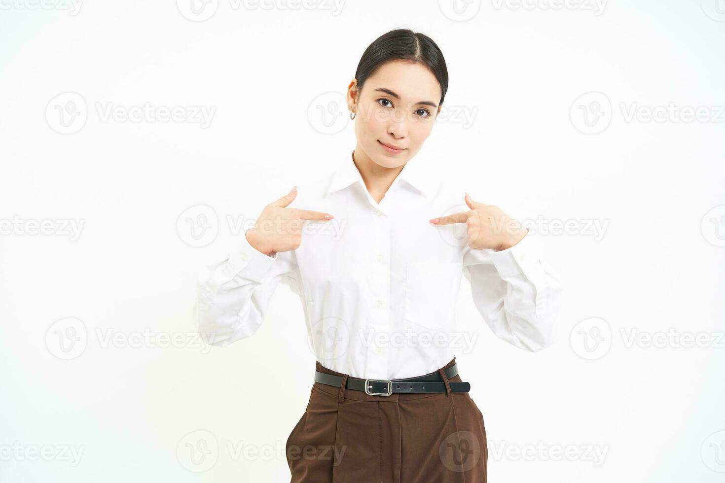 Business and corporate concept. Confident asian woman, saleswoman points at herself with serious face, white background photo