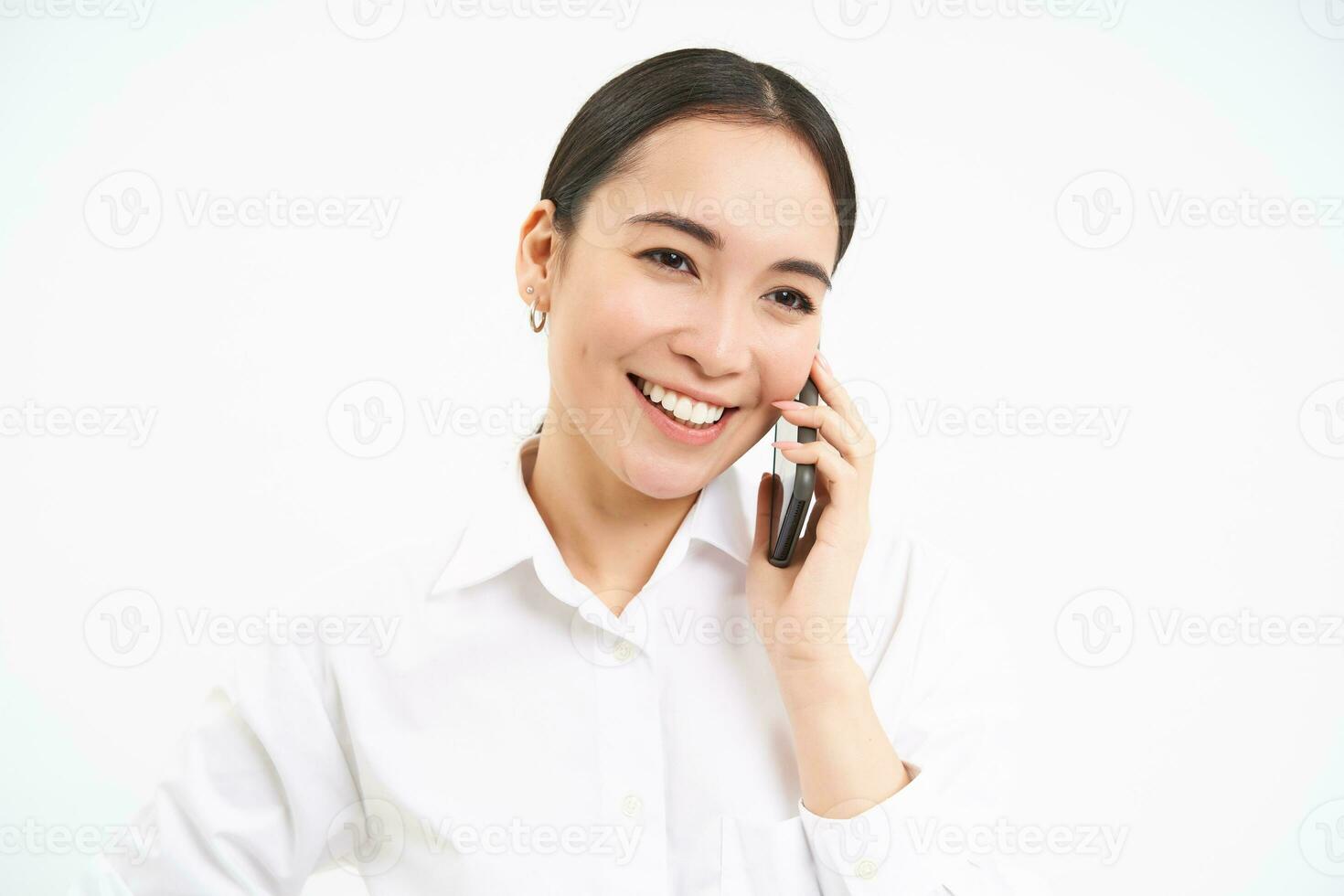 Portrait of asian corporate woman, businesswoman talks on mobile phone, has conversation over cellphone, speaking on telephone, white background photo