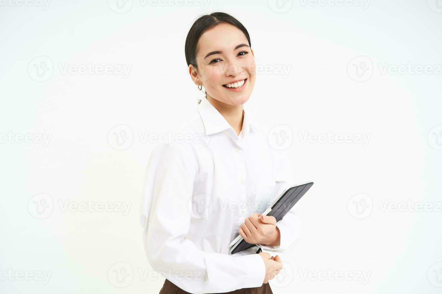 Corporate and young entrepreneurs concept. Successful businesswoman using digital tablet, prepares for meeting, looks at business concept on her gadget photo