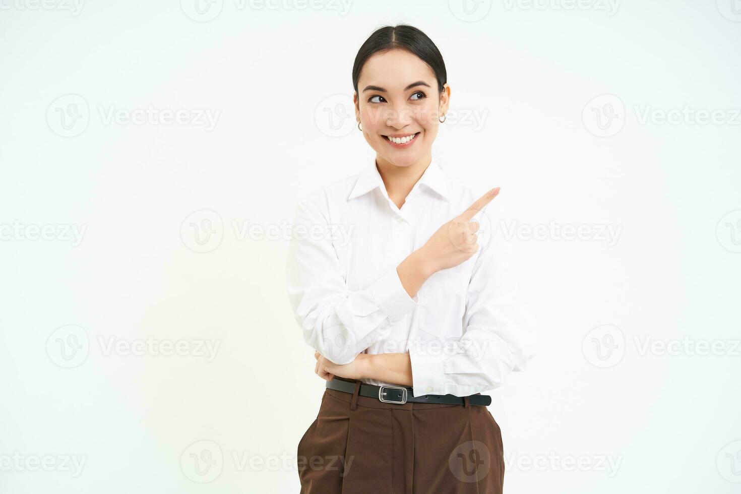 Image of asian businesswoman points finger to the right, shows advertisement, demonstrates banner, white background photo