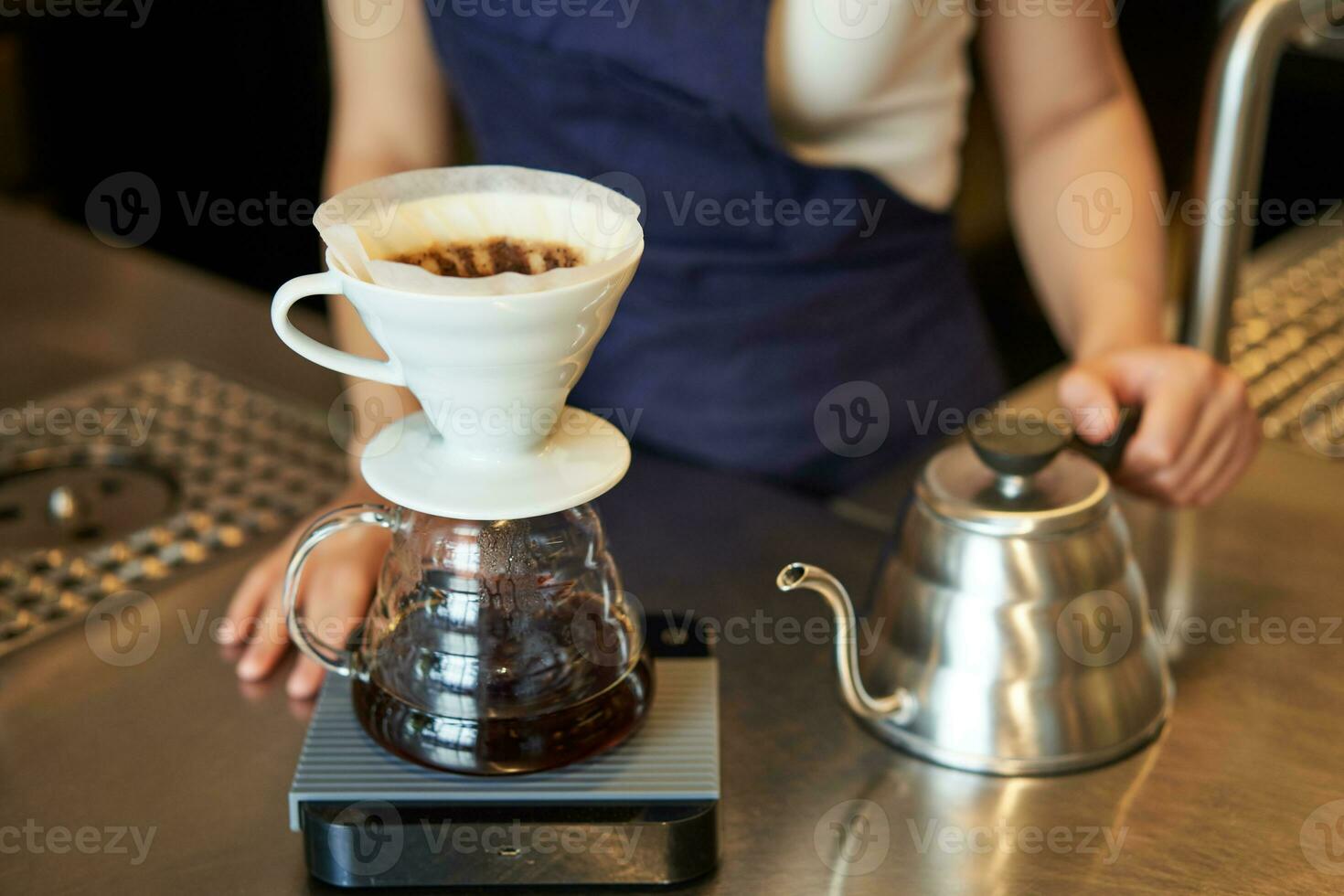 Close up of filter coffee brewing kit and kettle, cafe barista preparing filter at the counter photo