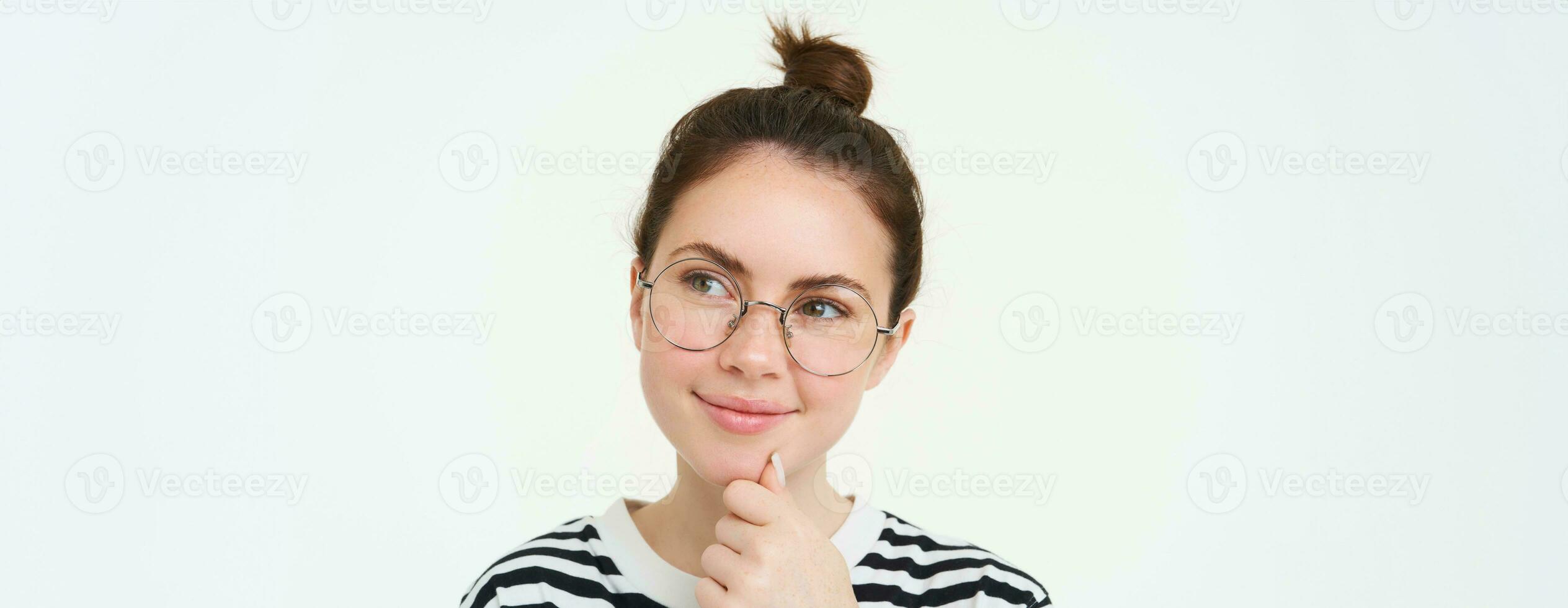 Portrait of pleased and thoughtful face, smiling satisifed, analizing smth, thinking, standing over white background photo