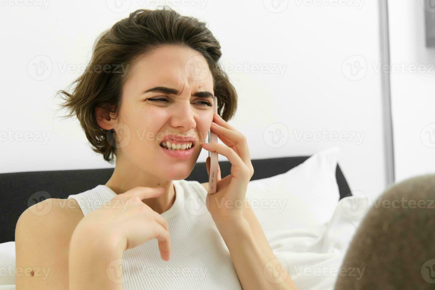 Portrait of woman flinching and grimacing from talking over