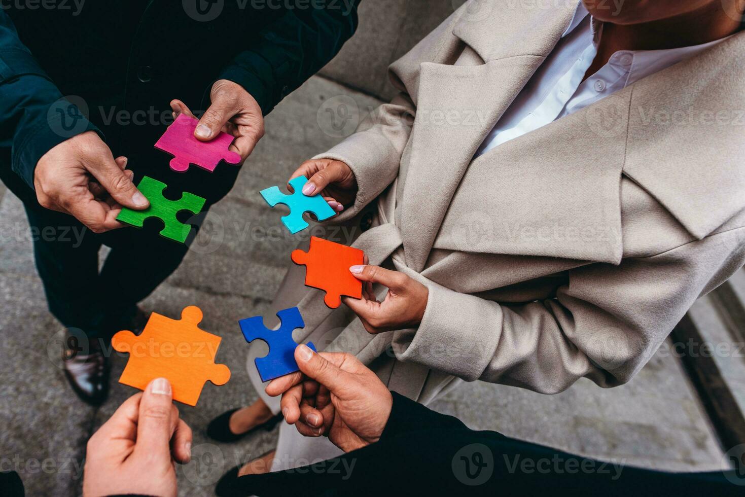 Businessmen working together to build a puzzle as teamwork, partnership and integration concept photo