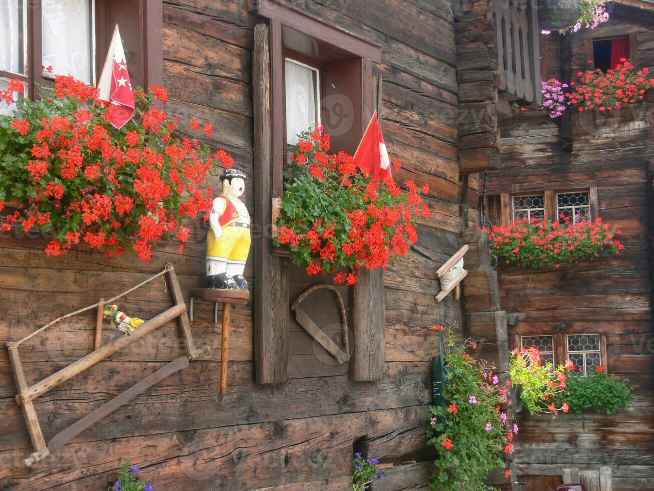 a wooden building with flowers in the windows photo