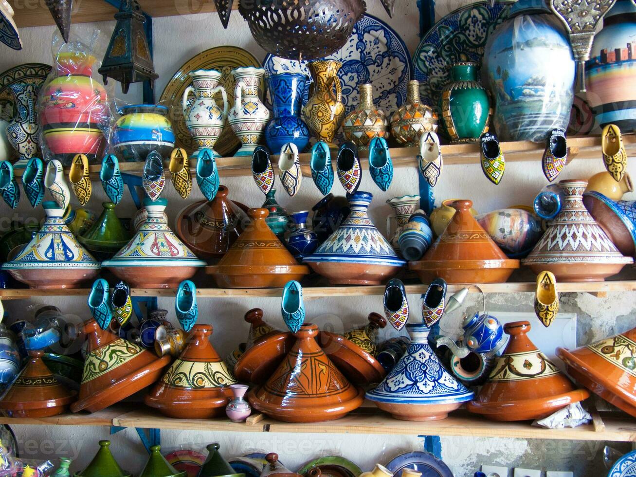 a shelf with many vases and pots on it photo