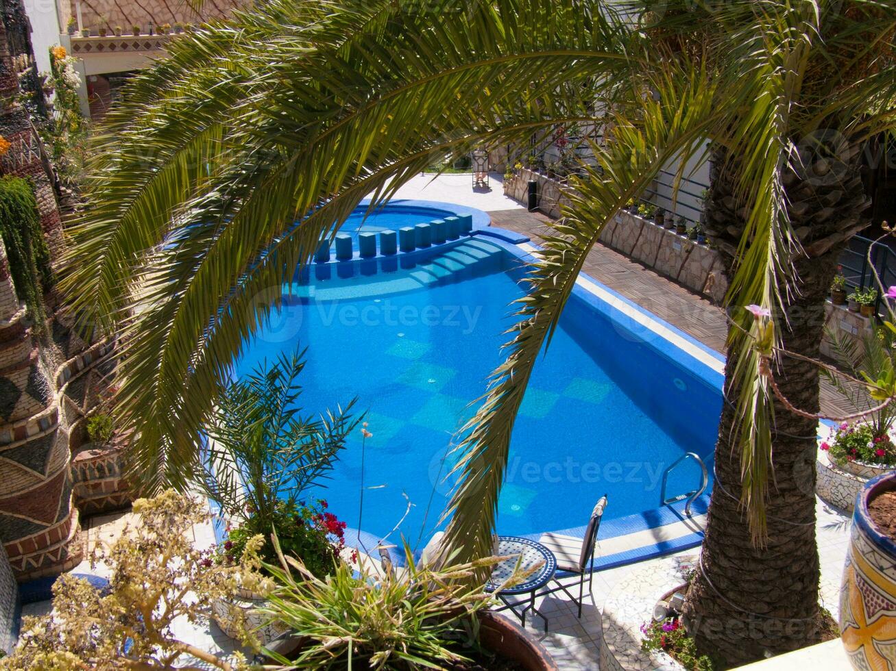 a pool with a blue fence photo