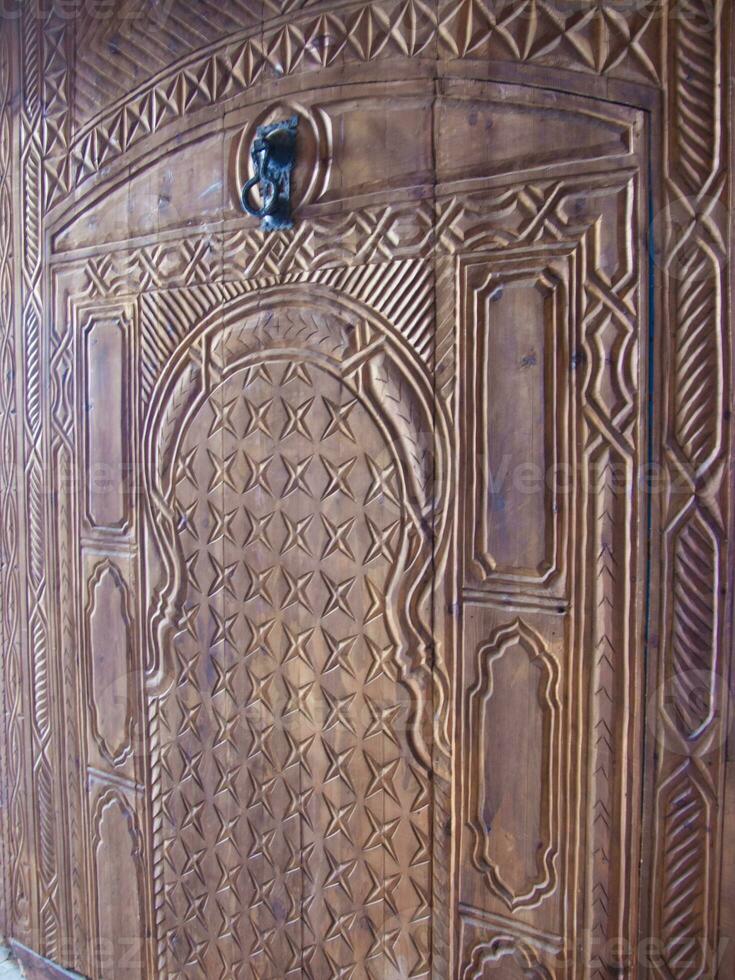 a carved wooden door with a decorative design photo