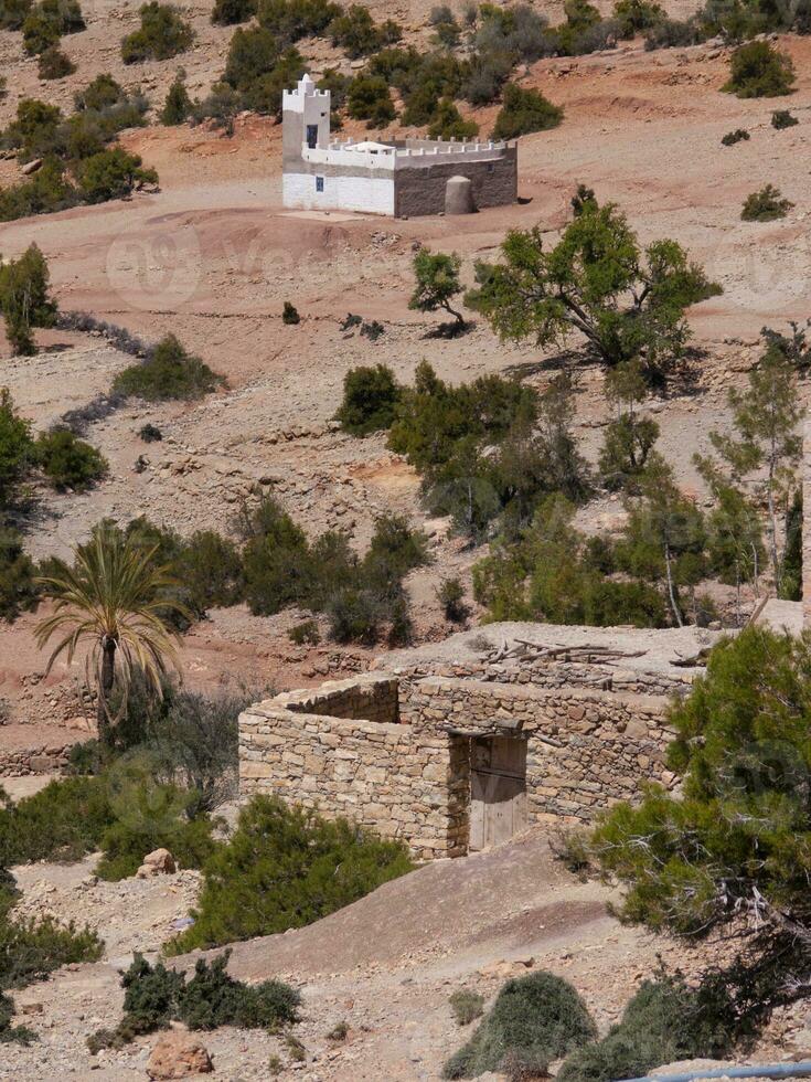 a small building with a clock on top photo