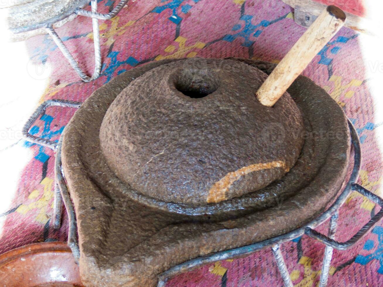 a large pot with a wooden stick sticking out of it photo