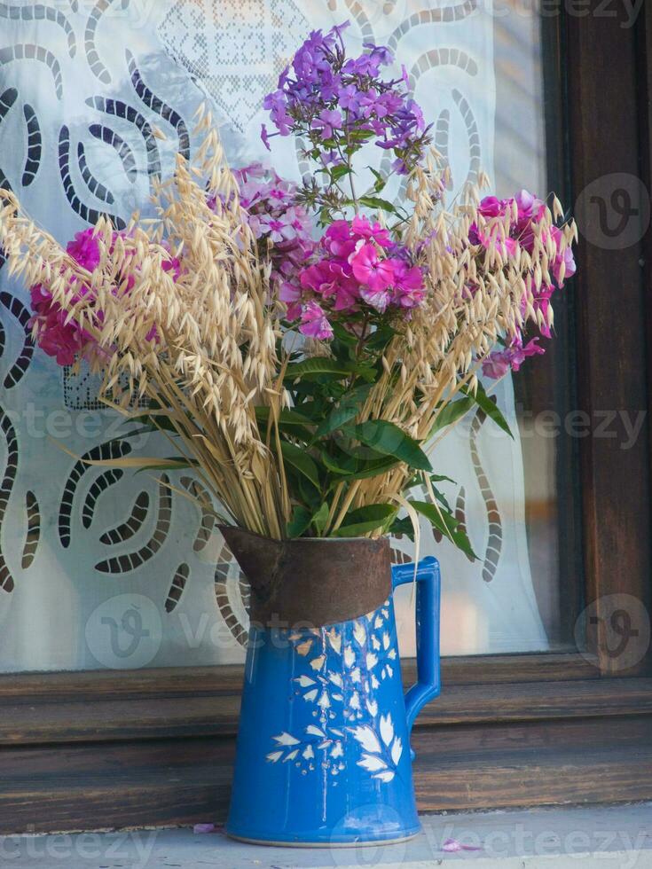 a blue vase with flowers photo